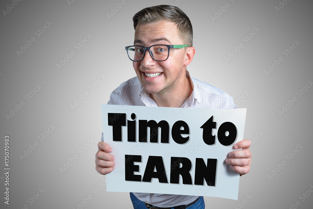 Funny laughing guy (men, student, businessman) of european appearance in casual clothes and glasses is holding a white sheet with text Time to Earn! Funny laughing guy (men, student, businessman) of european appearance in casual clothes and glasses is holding a white sheet with text Time to Earn!
