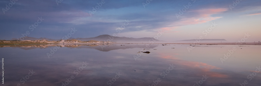 Pink and blue skies of winter above the lagoon on Noordhoek Beach, Cape Town, South Africa