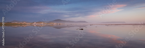 Pink and blue skies of winter above the lagoon on Noordhoek Beach, Cape Town, South Africa