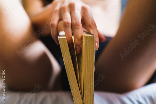 Seductive woman posing with book photo