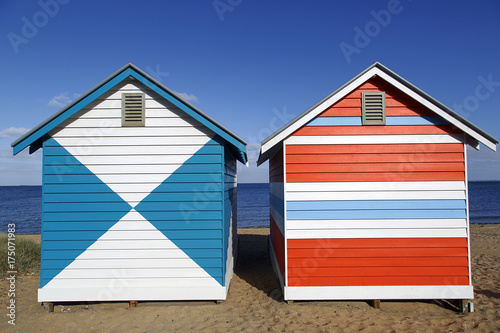 Two brightly painted beach huts on the iconic Brighton Beach in Melbourne