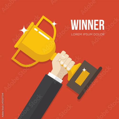 Hand holding a golden winner cup.