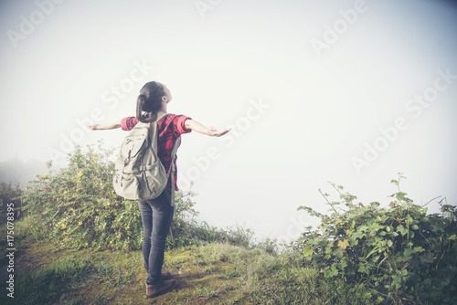 Happy hiker with her arms outstretched, freedom and happiness, achievement in mountains