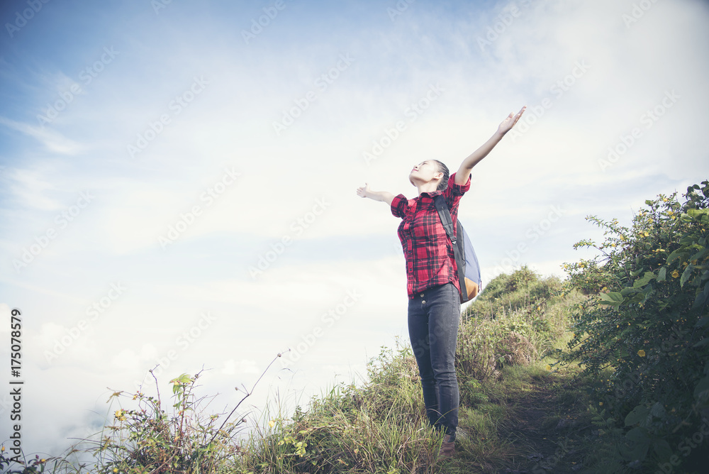 Freedom traveler woman standing with raised arms and enjoying a beautiful nature. Image with instagram filter Freedom traveler woman standing with raised arms and enjoying a beautiful nature. Image with instagram filter