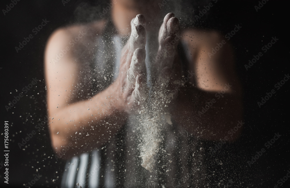 The man cook prepares flour products and meal-free flour on a glass table. Beautiful conceptual photo The man cook prepares flour products and meal-free flour on a glass table. Beautiful conceptual photo