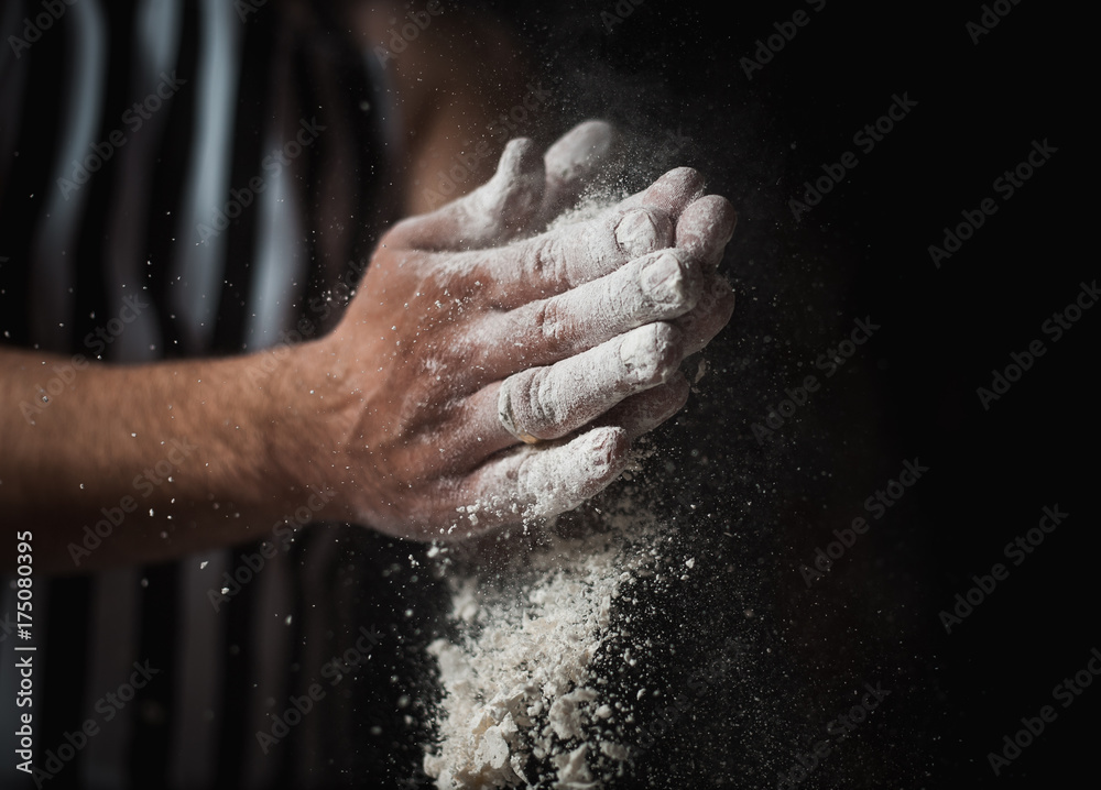 The man cook prepares flour products and meal-free flour on a glass table. Beautiful conceptual photo The man cook prepares flour products and meal-free flour on a glass table. Beautiful conceptual photo