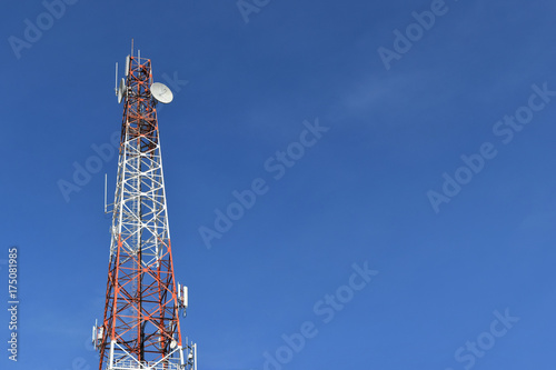 Antenna tower at blue sky and white clouds on a beautiful day.