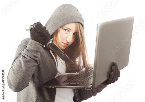 woman hacker holding knofe at laptop photo