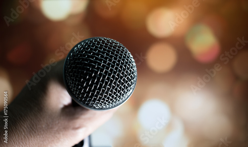 blurred of hands businesswoman speech and speaking with microphones in seminar room or talking conference hall light with microphones and keynote. Speech is vocalized form of communication humans.