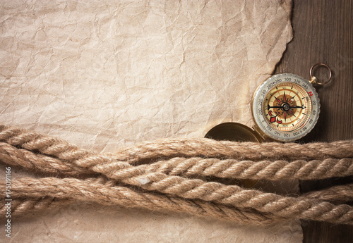 compass, old paper and rope