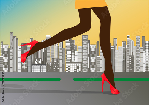 woman's slender legs in red high-heeled shoes run on the road against the background of skyscrapers
