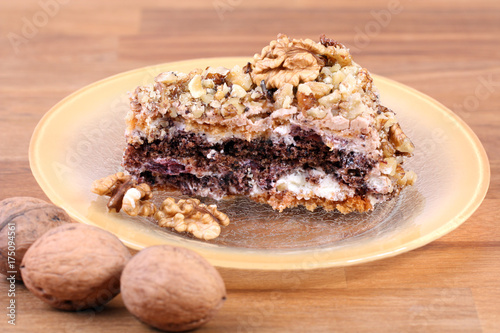 portion of white and brown chocolate walnut cake with walnuts