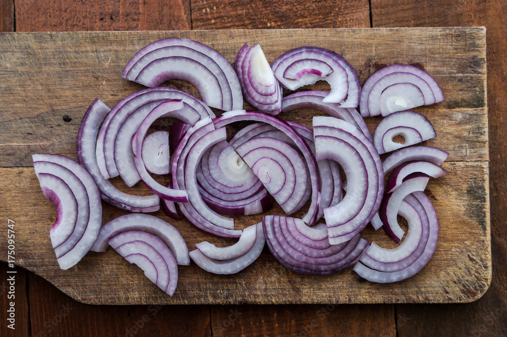 Food preparation, cooking concept: sliced fresh red onions on rustic wooden background Food preparation, cooking concept: sliced fresh red onions on rustic wooden background