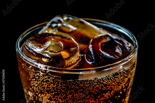 Cola with Ice,Food background.Glass of cola with ice cubes on black background.Glasses of sweet carbonated drinks with ice cubes,Close up.