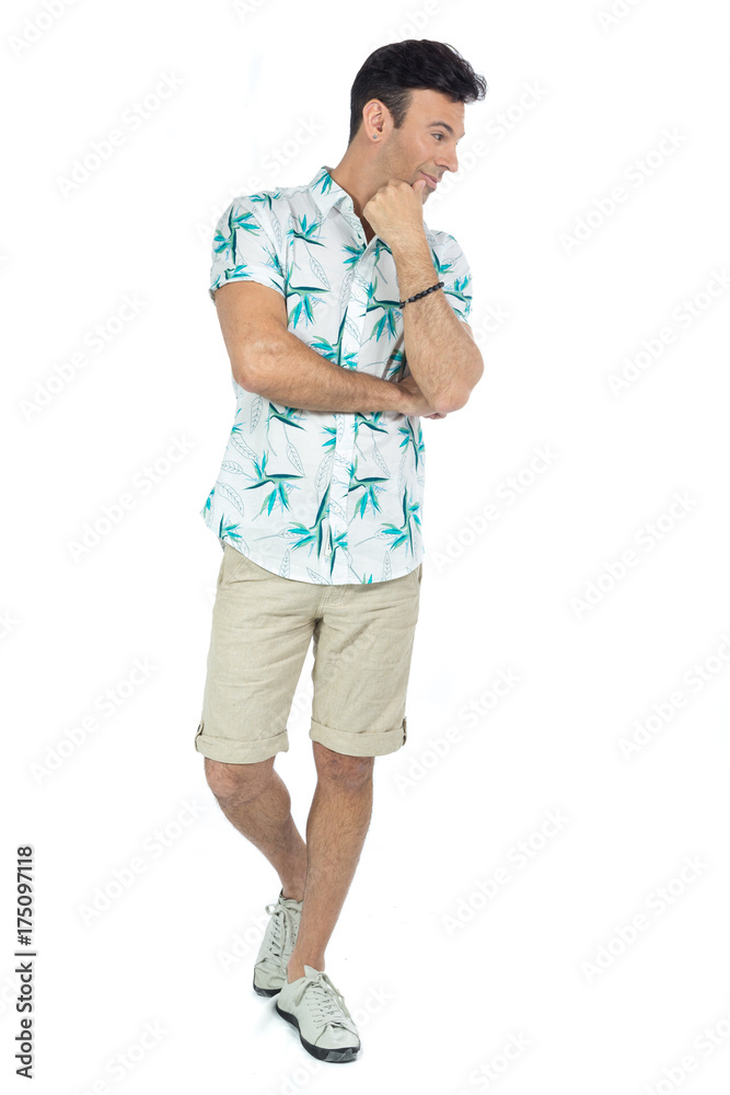 Man looks sideways and makes an assessment.Handsome brazilian male wears floral shirt.. Man looks sideways and makes an assessment.Handsome brazilian male wears floral shirt..
