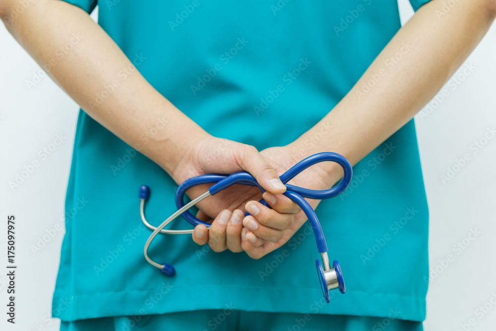 Doctors stand behind and cross hand with holding stethoscopes. Doctors stand behind and cross hand with holding stethoscopes.
