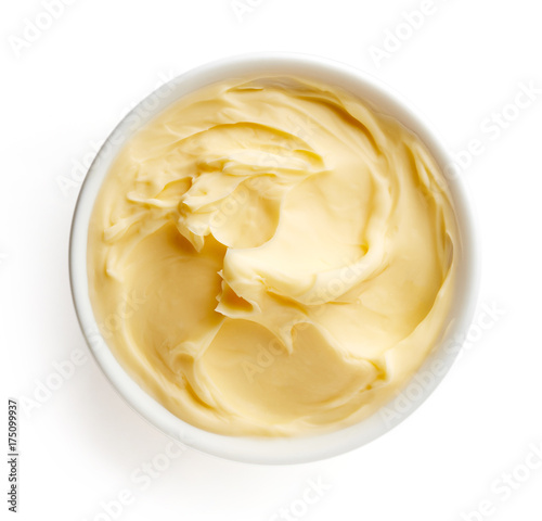 Bowl of butter isolated on white background, top view
