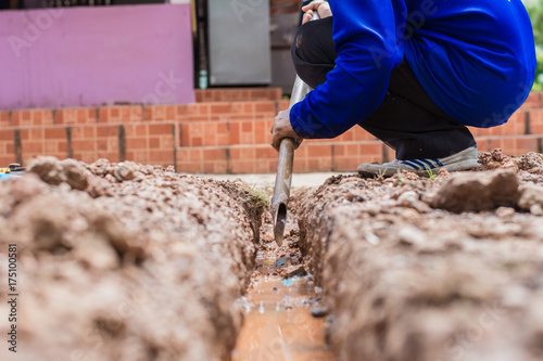 Construction worker,Repairing a broken water pipe on the concrete road.