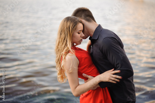 Beautiful loving couple n the background of water © fesenko