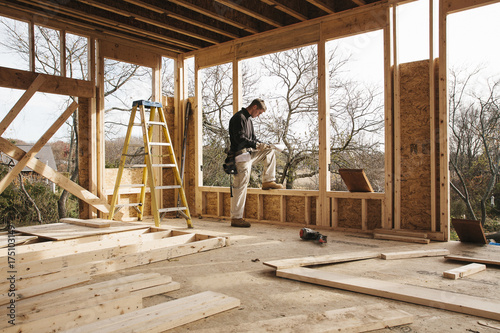 Man Reviewing Plans on Construction Site