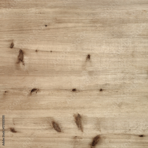 Rustic warm light brown wood board background with knots and grain