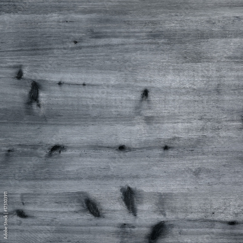 Rustic grey monochrome wood board background with knots and grain