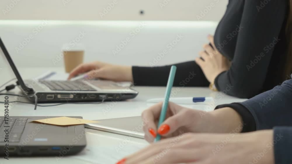 Two businesswoman works in the office, close-up Two businesswoman works in the office, close-up