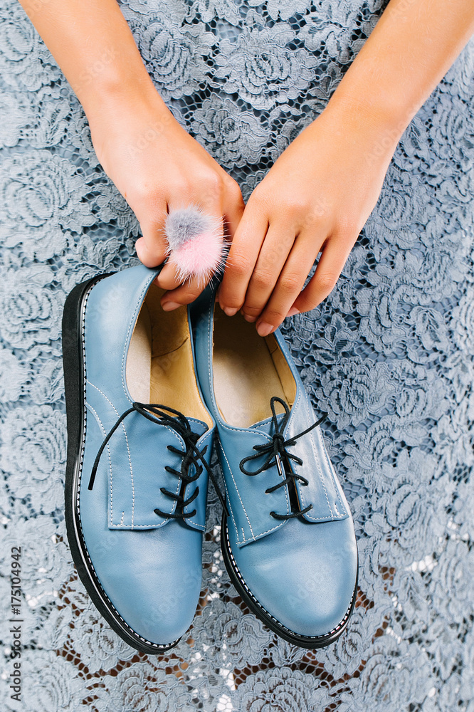 Female hands hold blue shoes, fashion concept. Female hands hold blue shoes, fashion concept.