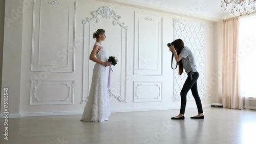 Photographer taking pictures the young sexy bride