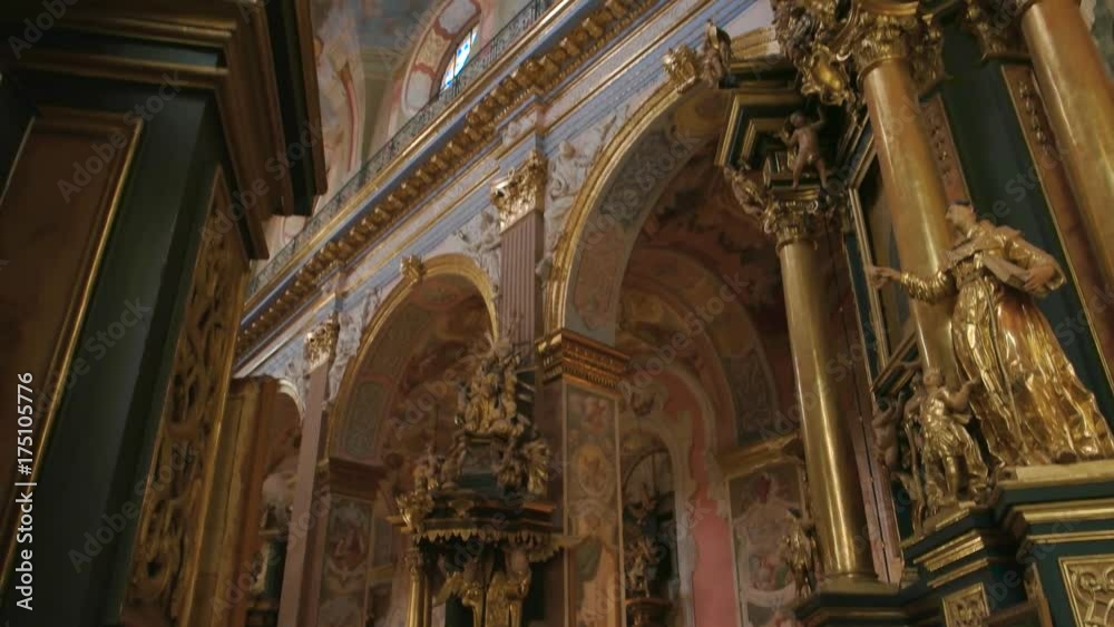 Beautiful Bernardine church interior. Golden sculptures and religious frescoes.