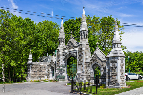 Gate of cemetery on Mont Royal during bright sunny day in Quebec region city
