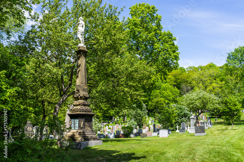 Cemetery on Mont Royal with statue during bright sunny day in Quebec region city