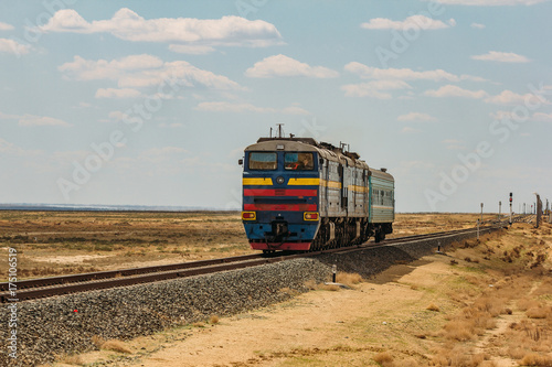 Locomotive train is passing through Kazakhstan desert