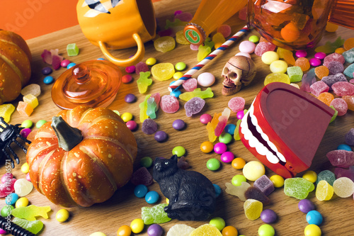 colorful halloween candy dessert party on wood ground