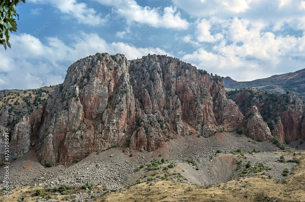 Fototapeta premium Picturesque red cliffs in front of the monastery complex Navorank.