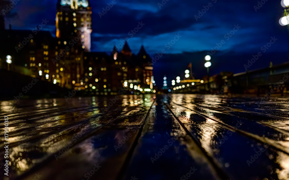 Old town closeup view of wet dufferin terrace at night with Chateau Frontenac