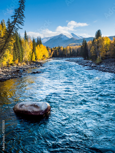 River view in autumn time with stone foreground, in Hemu village, Xinjiang, China. photo