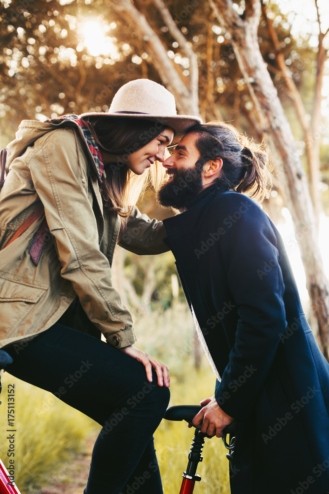 Young couple on a bicycle in the forest. Young couple on a bicycle in the forest.