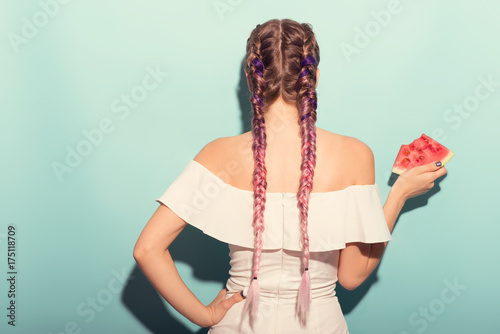 Stylish woman back hair. Cool hairstyle colorful braids. Summer portrait.