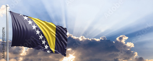 Foto Bosnia and Herzegovina flag on blue sky. 3d illustration