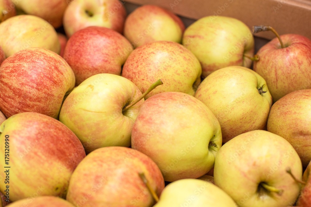 Beautiful appetizing fruit background with apples in a cardboard box Beautiful appetizing fruit background with apples in a cardboard box