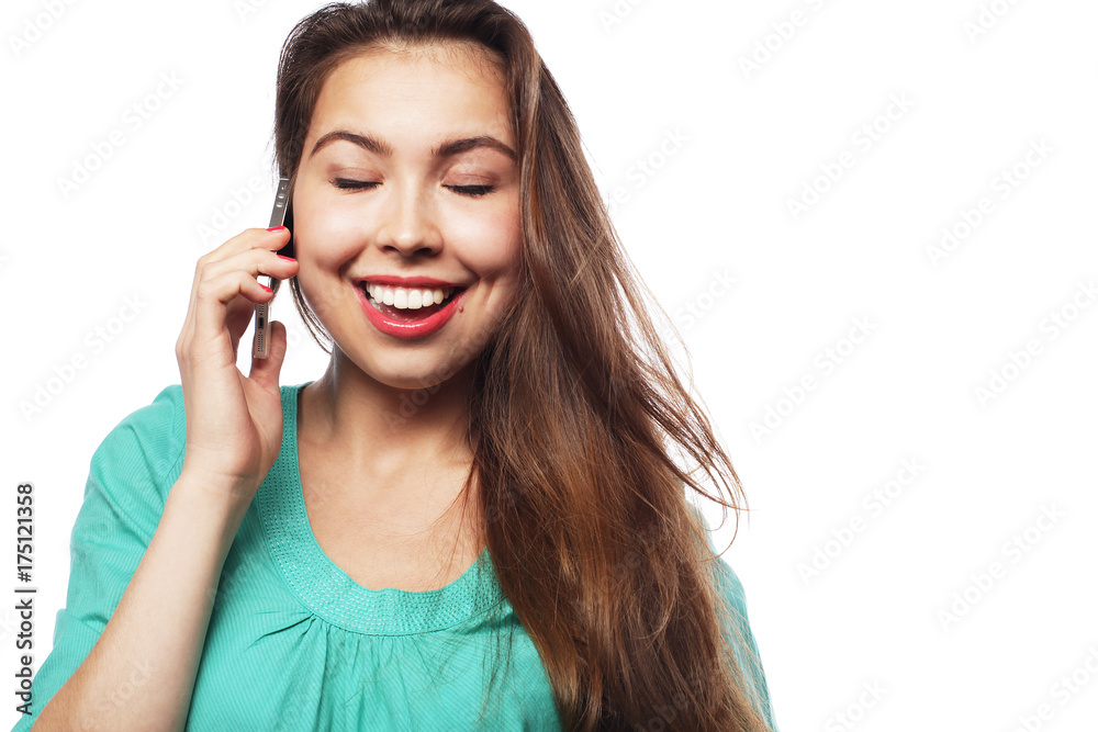 Cheerful woman talking on the phone isolated on a white backgrou Cheerful woman talking on the phone isolated on a white backgrou