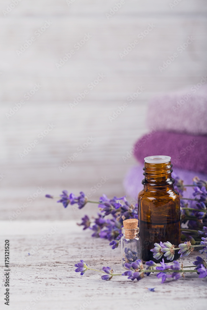 Bottle of essential oil and fresh lavender flowers Bottle of essential oil and fresh lavender flowers