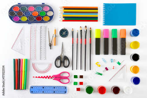Set of school supplies on white background. Paint, pencils, notepad, brushes, scissors.