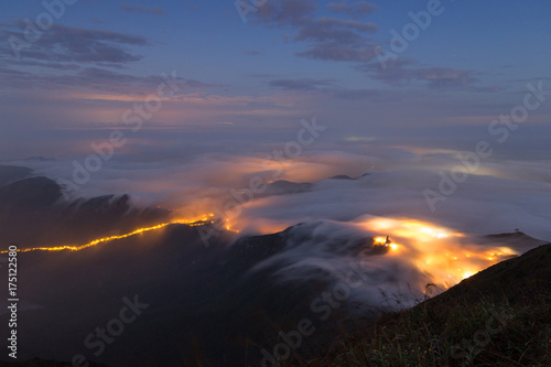 Clouds rolling over mountain on Lantau Island, viewed from the Lantau Peak (the 2nd highest peak in Hong Kong, China) at night.