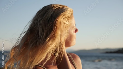 Caucasian fremale on the beach close-up footage - Slow motion woman relaxing on Mediterranean sea photo