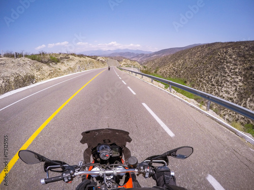 POV ridding a motorcycle on a road photo