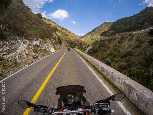 POV ridding a motorcycle on a road