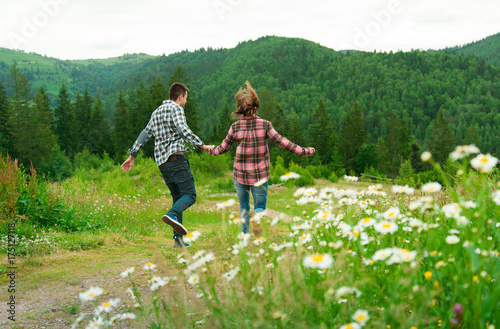 Young couple in love walking in mountains.