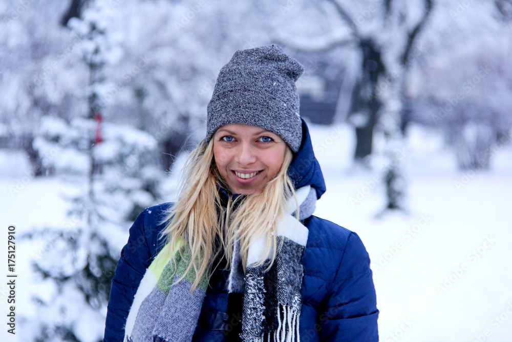 Beautiful winter portrait of young woman in the winter snowy scenery. Beautiful girl in winter clothes. Young woman portrait. beauty girl on the blurred background Beautiful winter portrait of young woman in the winter snowy scenery. Beautiful girl in winter clothes. Young woman portrait. beauty girl on the blurred background